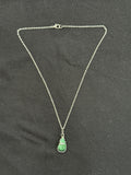 Full view of wrapped emerald stone pendant necklace with 22-inch silver chain