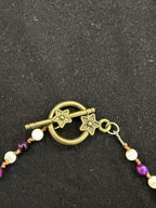 Close-up of floral-detail toggle clasp on the beaded choker necklace