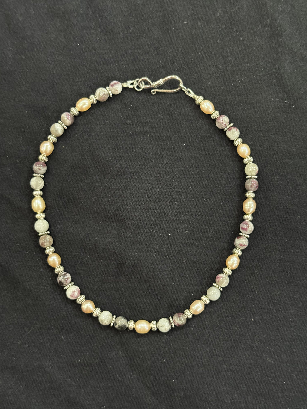 Full view of tourmaline and cultured pink pearl choker with imitation silver accents and stainless steel clasp