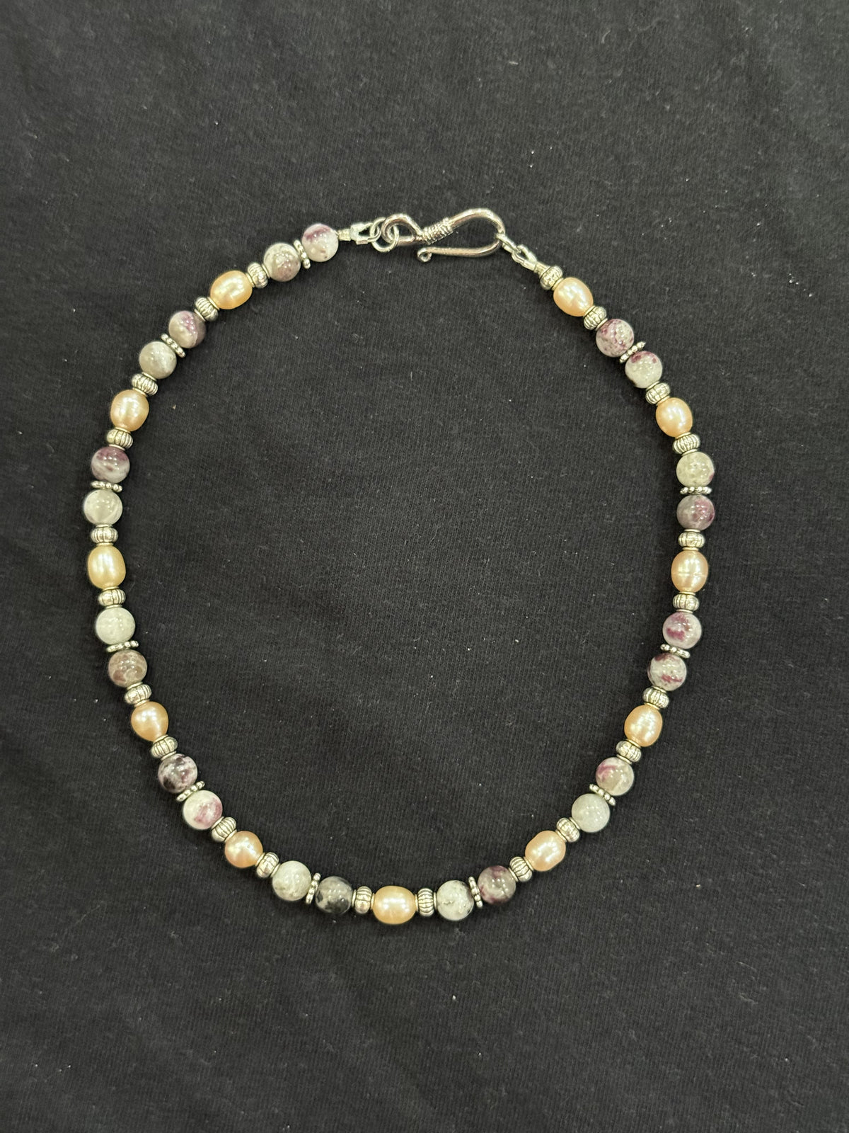 Full view of tourmaline and cultured pink pearl choker with imitation silver accents and stainless steel clasp