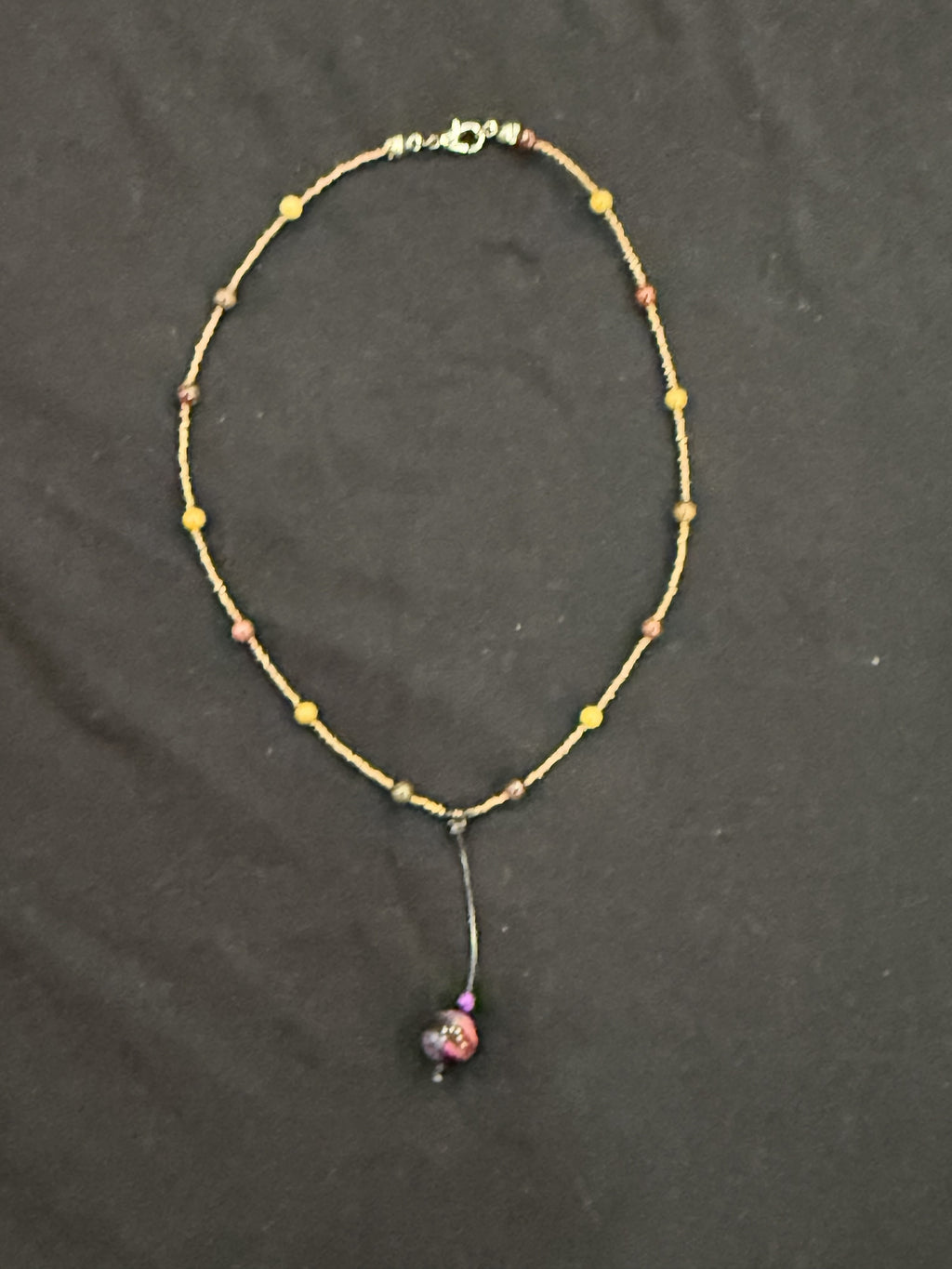 Full view of copper and mookaite choker with purple tiger’s eye bead on a leather drop