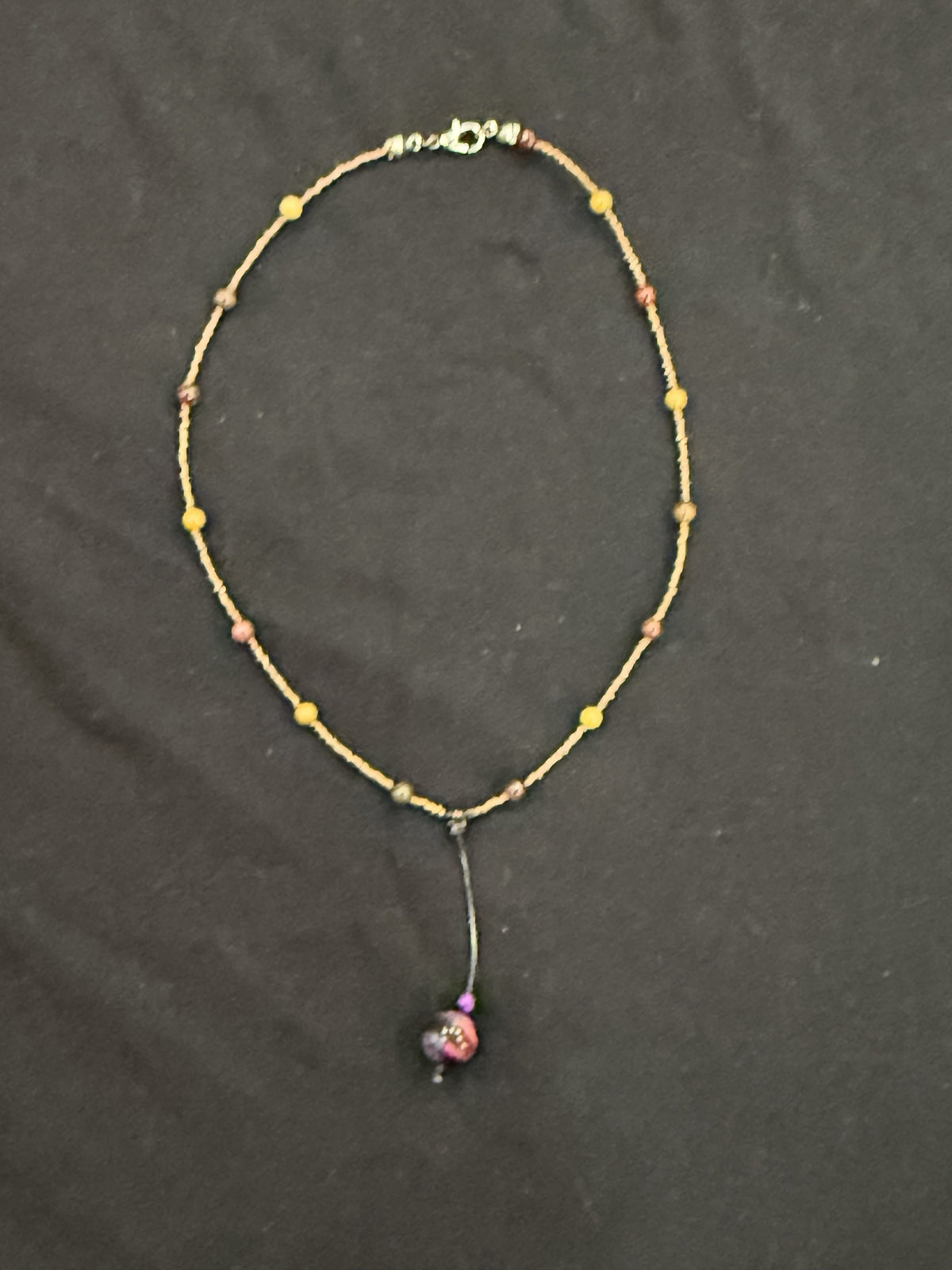 Full view of copper and mookaite choker with purple tiger’s eye bead on a leather drop