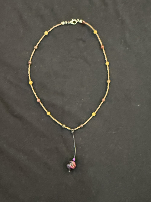 Full view of copper and mookaite choker with purple tiger’s eye bead on a leather drop