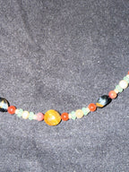Close-up of mixed gemstone beads and silver accents on the choker