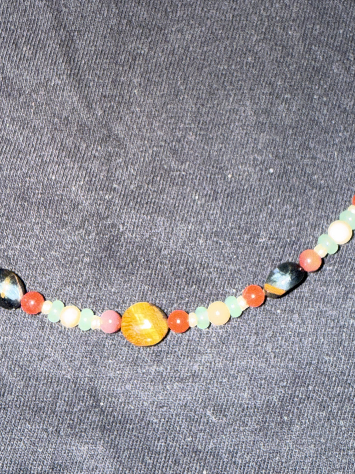 Close-up of mixed gemstone beads and silver accents on the choker