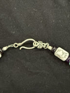 Close-up of decorative hook clasp and veined white howlite bead