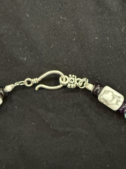 Close-up of decorative hook clasp and veined white howlite bead