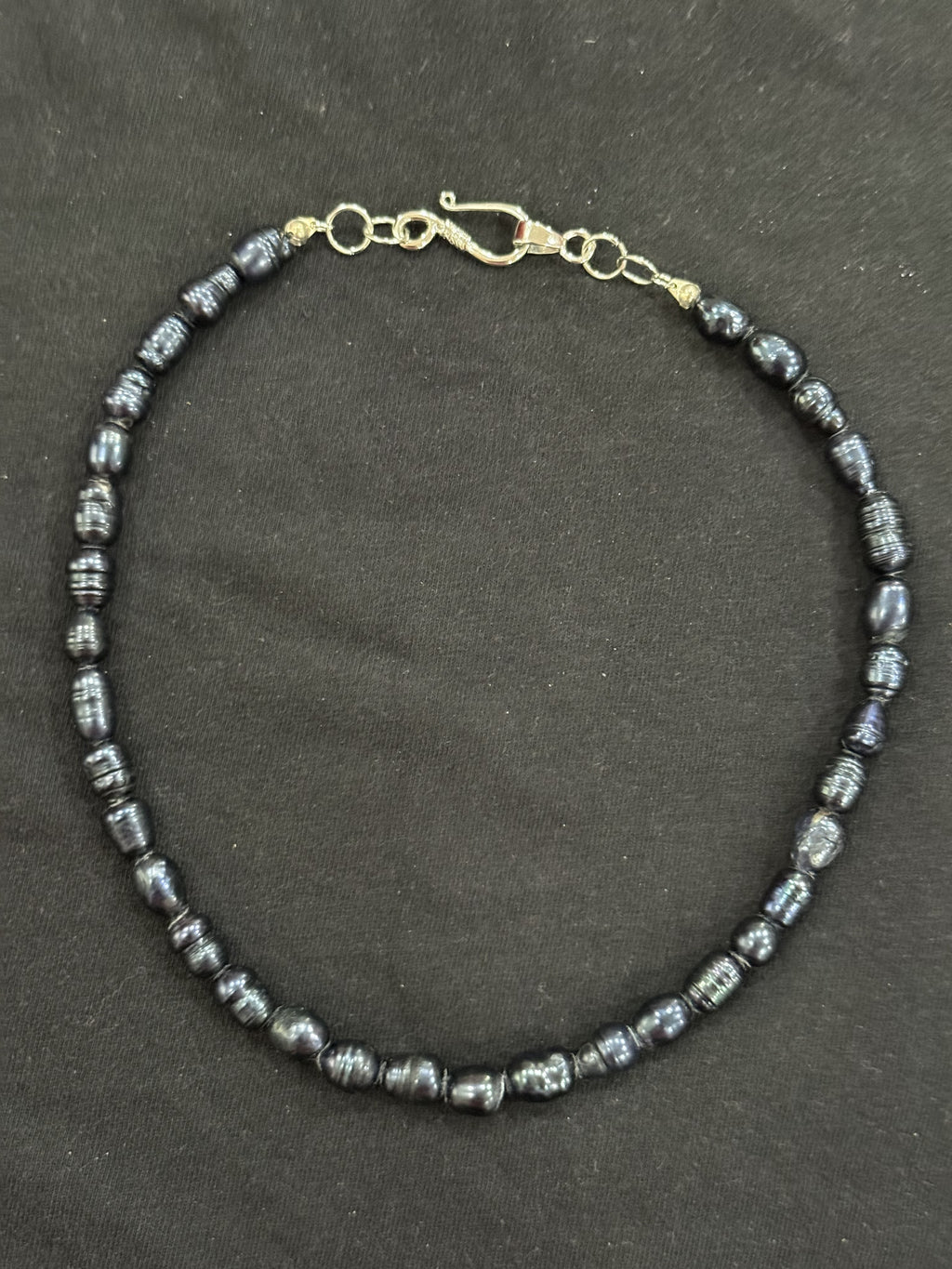 Full view of blue uncultured pearl necklace with silver hook clasp