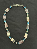 Full view of flat rectangular porcelain jasper necklace with blue and purple tourmaline accents