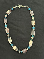 Full view of flat rectangular porcelain jasper necklace with blue and purple tourmaline accents
