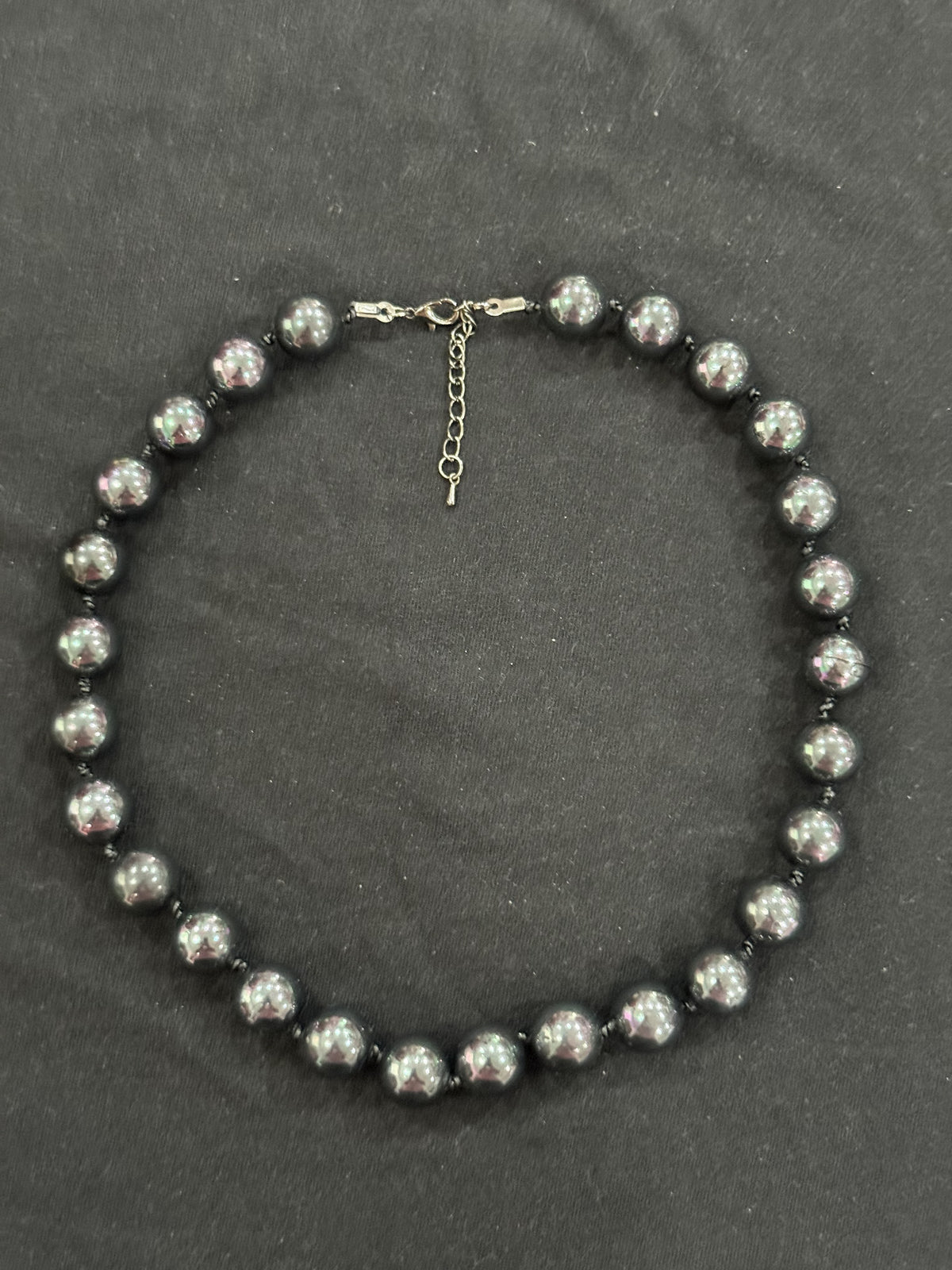 Close-up of lustrous Tahitian cultured pearls and knots in the leather cord