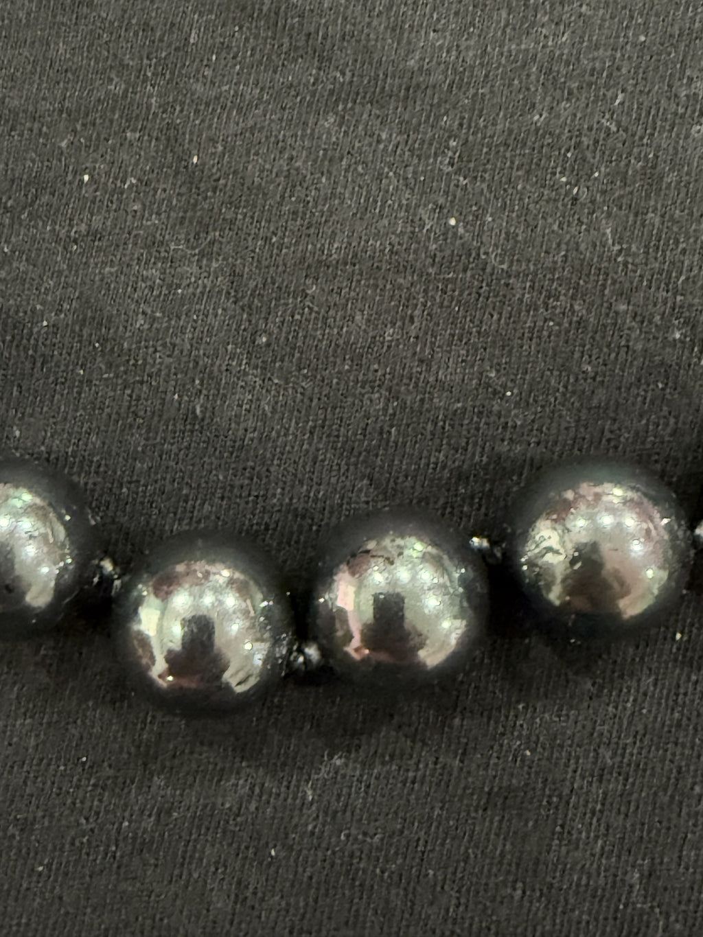 Full view of Tahitian cultured pearl necklace on knotted leather with adjustable clasp and chain