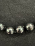Full view of Tahitian cultured pearl necklace on knotted leather with adjustable clasp and chain