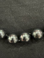 Full view of Tahitian cultured pearl necklace on knotted leather with adjustable clasp and chain
